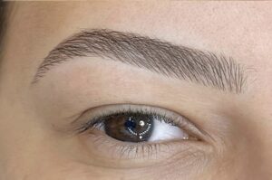 Close-up of nanoblading semi permanent makeup in London showing ultra-fine hair strokes for natural-looking brows