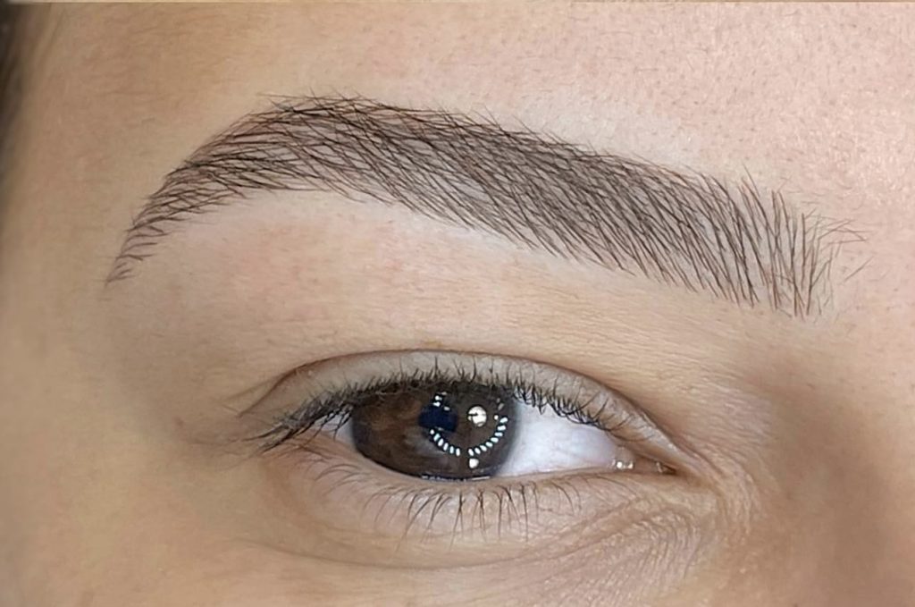 Close-up of nanoblading semi permanent makeup in London showing ultra-fine hair strokes for natural-looking brows